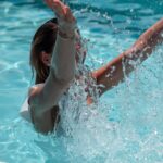 woman in white bikini top in water
